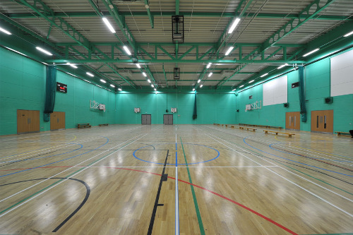 The sports hall at the Sir Robert Woodard Academy in West Sussex, for which Luxonic Lighting has supplied the complete controls and lighting solution.
